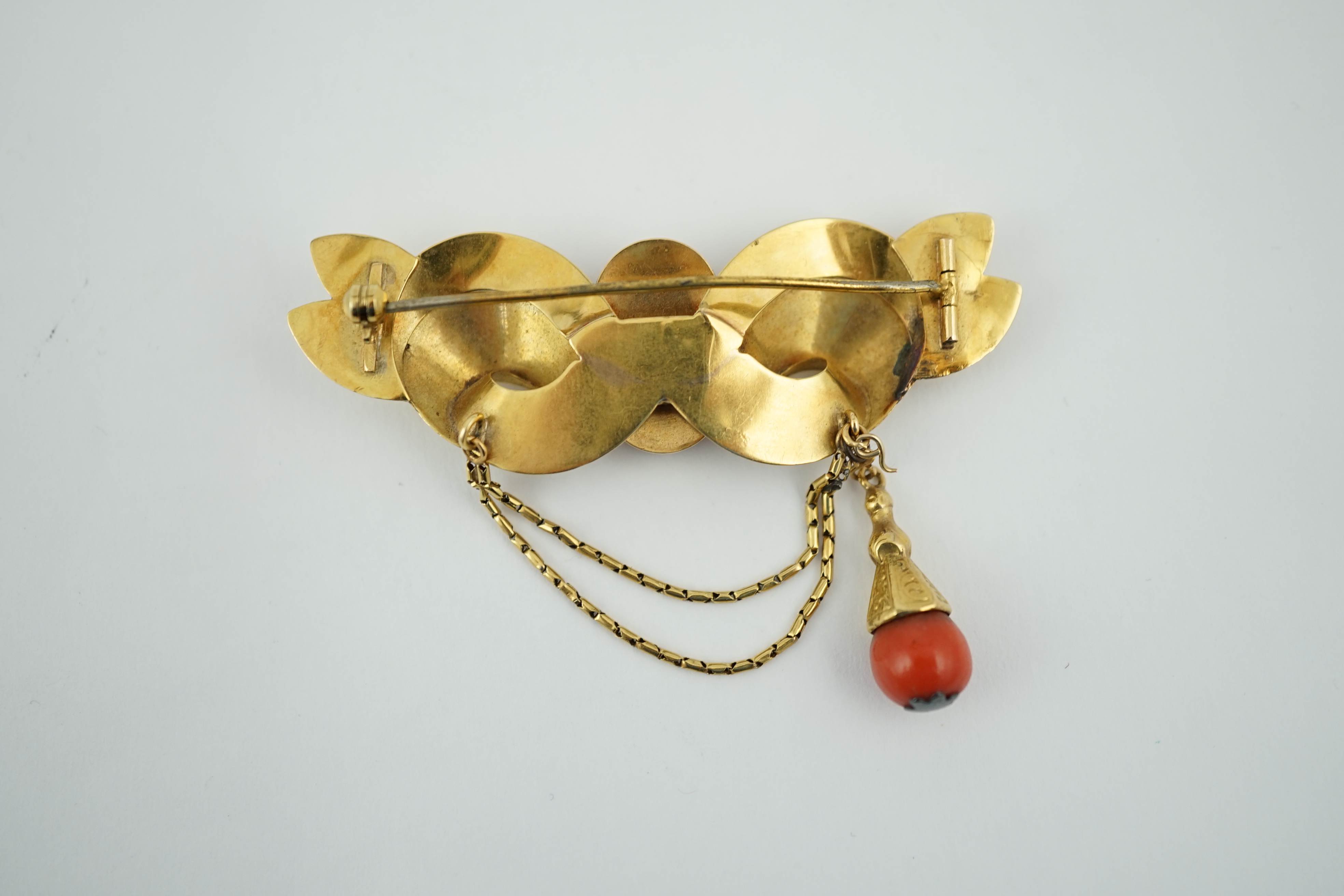 An early 20th century engraved gold and coral set drop brooch